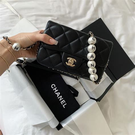 chanel pearl logo bag|Chanel bag with pearl chain.